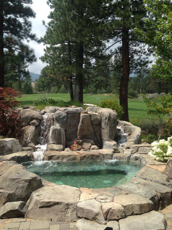 Custom pond with waterfall and fire pit made by Robert Allen Pools
